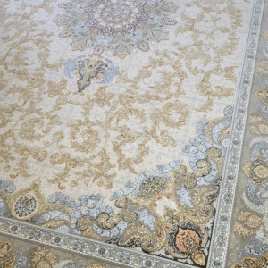 A traditional Persian style rug with beige as the primary color and intricate floral and geometric patterns.